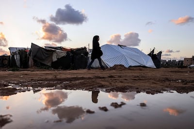 A woman walks through Gaza's Nuseirat Refugee Camp on Thursday. Israel's devastation of Gaza following the Hamas-led attack of October 7, 2023, has caused support for Israel in the US to fall. AFP