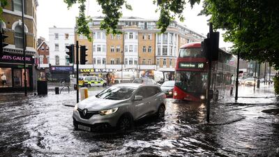 A car negotiates a flooded section of road, as torrential rain and thunderstorms hit the country on August 17, 2022 in London, England. Getty Images