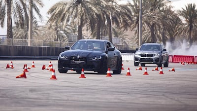 An M4 driver takes on a slalom course.