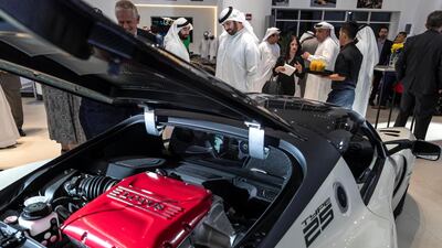 Visitors discuss the cars.