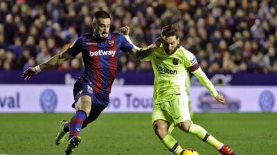 Lionel Messi in action against Levante's defender Erick Cabaco. EPA