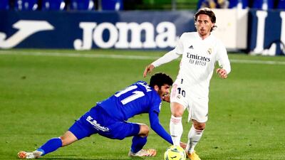 Real Madrid's Luka Modric in action with Getafe's Carles Alena. Reuters