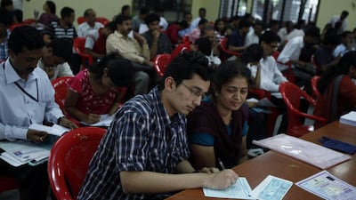 A candidate fills in an application for the Common Entrance Test to secure an engineering seat in Bangalore. Aijaz Rahi / AP Photo