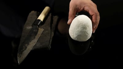 A worker helps Omar Sartawi, a Jordanian chef, as he recreates an ancient statue found in Jordan using a famous local product - Jameed (dried goatÕs milk used in the country's national dish), at his workshop in Amman, Jordan. REUTERS