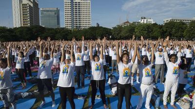 Hundreds of participants attend a mass yoga session at the grounds of Chulalongkorn University in Bangkok. Romeo Gacad / AFP