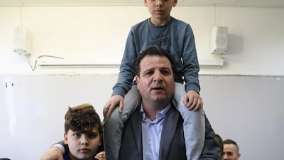 Ayman Odeh, leader of Hadash-Ta'al party, casts his ballot together with his sons as Israelis began voting in a parliamentary election, at a polling station in Haifa. Reuters