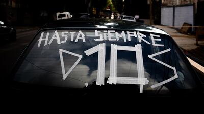 The back window of a car displays 'So long, God'. Getty