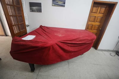 In 2018, the Palestinian piano sat in an office under a protective cloth, with a note that read: ‘no touch’. Nagham Mohanna for The National