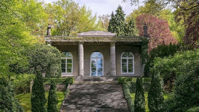 The 5,000-square-foot villa is set on 2.9 acres of lush greenery, with high-growing hedges and dense foliage. Courtesy Engel & Volkers / Herbert Ohge