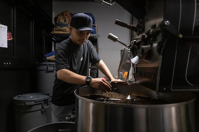 Gabriel Kisworo, from Nightjar’s roastery, roasts and packs coffee beans as they continue operations. Antonie Robertson / The National