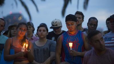Community members gather for a vigil to honour the victims of a mass shooting at a nightclub, at Eola Lake Park in Orlando, Florida. Ryan Stone / EPA