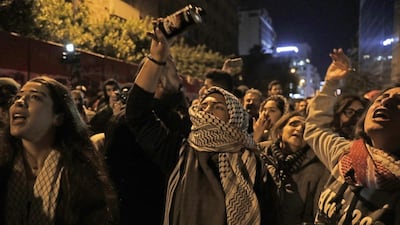 Demonstrators chant slogans as they gather in front of the central bank headquarters in Beirut. AFP