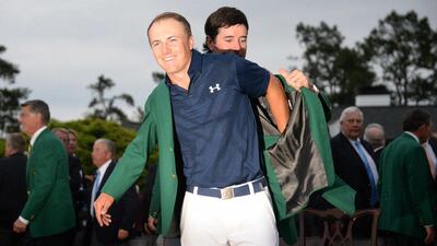 Last year's Masters winner Bubba Watson puts the iconic Green Jacket on Jordan Spieth after his Masters victory. Jim Watson / AFP