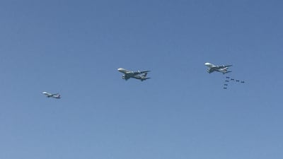 An air convoy featuring two A380s and seven stunt jets can be seen in this picture taken from the Palm. Rory Reynolds / The National