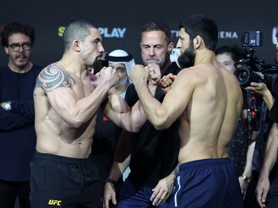 Robert Whittaker, left, and Khamzat Chimaev square up during the ceremonial weigh-in at Etihad Arena. Chris Whiteoak / The National