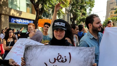 A Lebanese protester holds a placard reading in Arabic 'shake the dust of fear off homeland' during students protest in Beirut. EPA