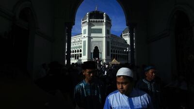 Indonesian Muslims walk out of a mosque after attending prayers in Medan, North Sumatra, Indonesia. EPA