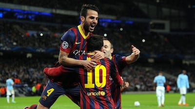 Lionel Messi and Cesc Fabregas celebrate after Barca's first goal on Tuesday night. Peter Powell / EPA