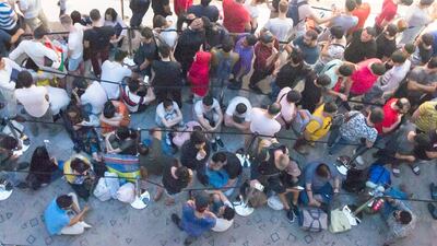Apple customers queue through the night at The Dubai Mall to be one of the first to get the new Apple devices. Leslie Pableo / The National