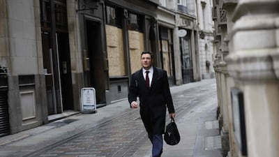 A pedestrian walks in the City of London. The Bank of England said Friday that UK banks remained "resilient" to the risks of Brexit and coronavirus, but warned financial services could face "disruption" when the transition period ends. AFP