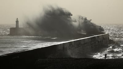 Large waves hit the harbour wall at sunrise in Newhaven, East Sussex, England. Reuters