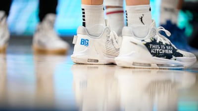 Dallas Wings' Marina Mabrey wears shoes that have a "BG" logo on them, a reference to Brittney Griner, during the second half of the team's WNBA basketball game against the Indiana Fever, Thursday, June 23, 2022, in Arlington, Texas. AP