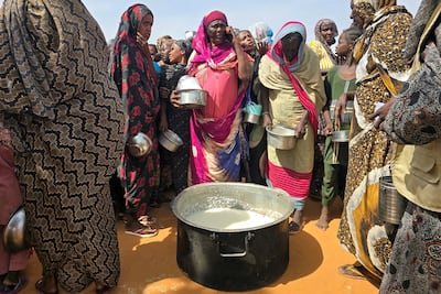 Sudanese women gather for a hot meal in al-Rahmaniyah camp for displaced people, near the city of El-Obeid in the southern Kordofan region in July. AFP