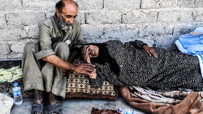 Wounded Syrians rest on the front line in eastern Raqqa on July 13, 2017. AFP