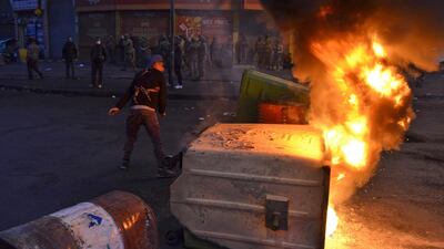 Lebanese anti-government protesters burn dumpsters to block al-Nour Square in Lebanon's northern port city of Tripoli. AFP