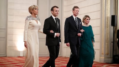 Brigitte, wearing a white silk Louis Vuitton gown with an embellished shoulder, with Emmanuel Macron, Grand Duke of Luxembourg Henri and his wife Maria Teresa, on March 19, 2018. AFP