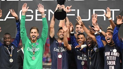 Paris Saint-Germain players celebrate with the French Super Cup trophy (Trophee des Chmpions) after defeating Lyon in the French season curtain-raiser on Saturday. Boris Horvat / AFP / August 6, 2016