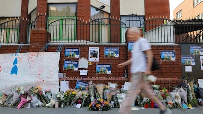 A man walks past flowers left outside Finsbury Park Mosque in north London. Tolga Akmen / AFP