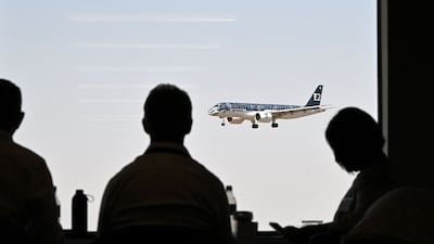 Members of the media watch an Embraer E190-E2 passenger aircraft during a flying display at the Farnborough Airshow on July 19, 2022. AFP