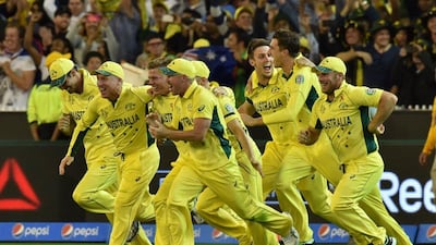 Australia players charge the MCG pitch after winning the 2015 cricket World Cup. Saeed Khan / AFP