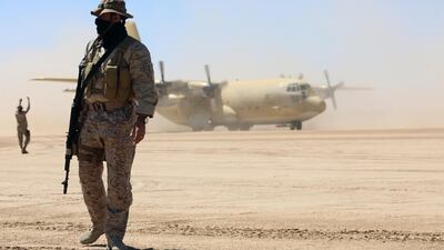 Saudi soldiers stand guard as a Saudi air force cargo plane, carrying aid, lands at an airfield in Yemen's central province of Marib, on February 8, 2018. AFP