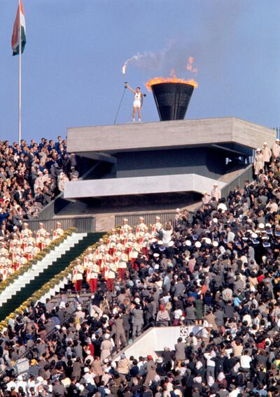 Yoshinori Sakai touches the Olympic torch to the urn signifying the start of the 1964 summer games in Tokyo Corbis