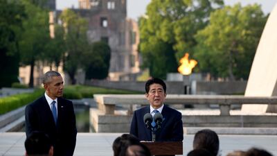 Former US President Barack Obama, left, looks to Japanese Prime Minister Shinzo Abe as he speaks during a ceremony at the cenotaph at Hiroshima Peace Memorial Park in Hiroshima, western, Japan, on May 27, 2016. Carolyn Kaster / AP