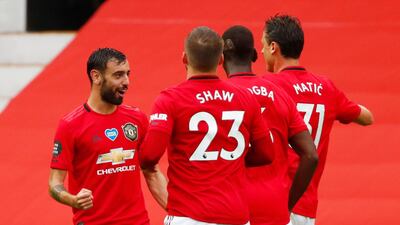 Manchester United's Bruno Fernandes celebrates with teammates after scoring a free-kick. Reuters