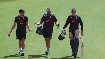 England's Jos Buttler, right along-with support staff arriving at training. AP