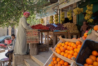 An Egyptian arranges fruits at a shop in Cairo, Egypt. AFP