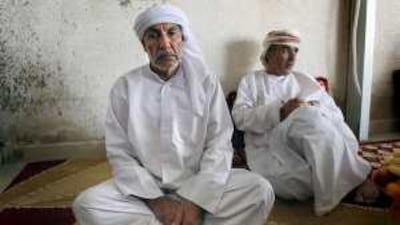 Mohammed Hassan, Ali's father, at his home in the Al Rashidiya district of Dubai with Ismael Abdullah, right, a cousin from Oman.