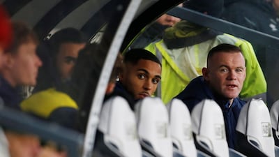 Wayne Rooney watches the Derby v QPR match from the dugout. Reuters