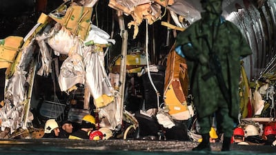 A Turkish soldier stand guard as rescuers work to extract passengers from the crash of a Pegasus Airlines Boeing 737 airplane, after it skidded off the runway upon landing at Sabiha Gokcen airport in Istanbul on February 5, 2020. The plane carrying 171 passengers from the Aegean port city of Izmir split into three after landing in rough weather. Officials said no-one had lost their lives in the accident, but dozens of people were injured. / AFP / Ozan KOSE