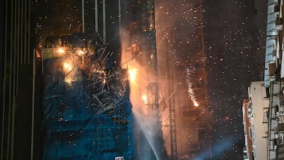 Burning debris falling from the under-construction building on fire. AFP