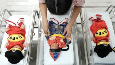 A nurse checks in on newborns wearing Chinese traditional costumes to celebrate the Chinese New Year at the nursery of Paolo Chockchai 4 Hospital, in Bangkok, Thailand on January 27, 2017. Athit Perawongmetha / Reuters