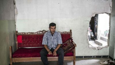 Abdullah Kurdi, the father of three-year-old Alan, sits in a relative’s house in Kobani, Syria, on September 6, 2015. Yasin Akgul / AFP