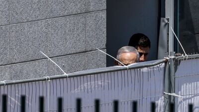 Israeli Prime Minister Benjamin Netanyahu walks behind a screen during a visit to the site of rocket attack that killed 12 children in the Druze-majority town of Majdal Shams, in the Israeli-occupied Golan Heights. Residents protested against Netanyahu's visit while he vowed Israel would deliver a "severe" response. AFP