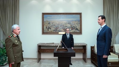 A handout photo made available by the official Syrian Arab News Agency (SANA) shows the newly-named Syrian Defense Minister Ali Abdullah Ayyoub (L) being sworn in before Syrian President Bashar al-Assad (R), in Damascus, Syria. EPA/SANA.