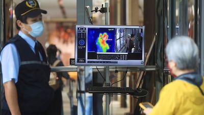 A thermal camera detects the body temperature of a customer as a measure to prevent the spread of the coronavirus disease (COVID-19) at an entrance of a restaurant, in Taipei, Taiwan, November 30, 2021. Reuters