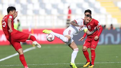 Doan Van Hau, left, of Vietnam in action against Seyed Ashkan Dejagah of Iran. EPA